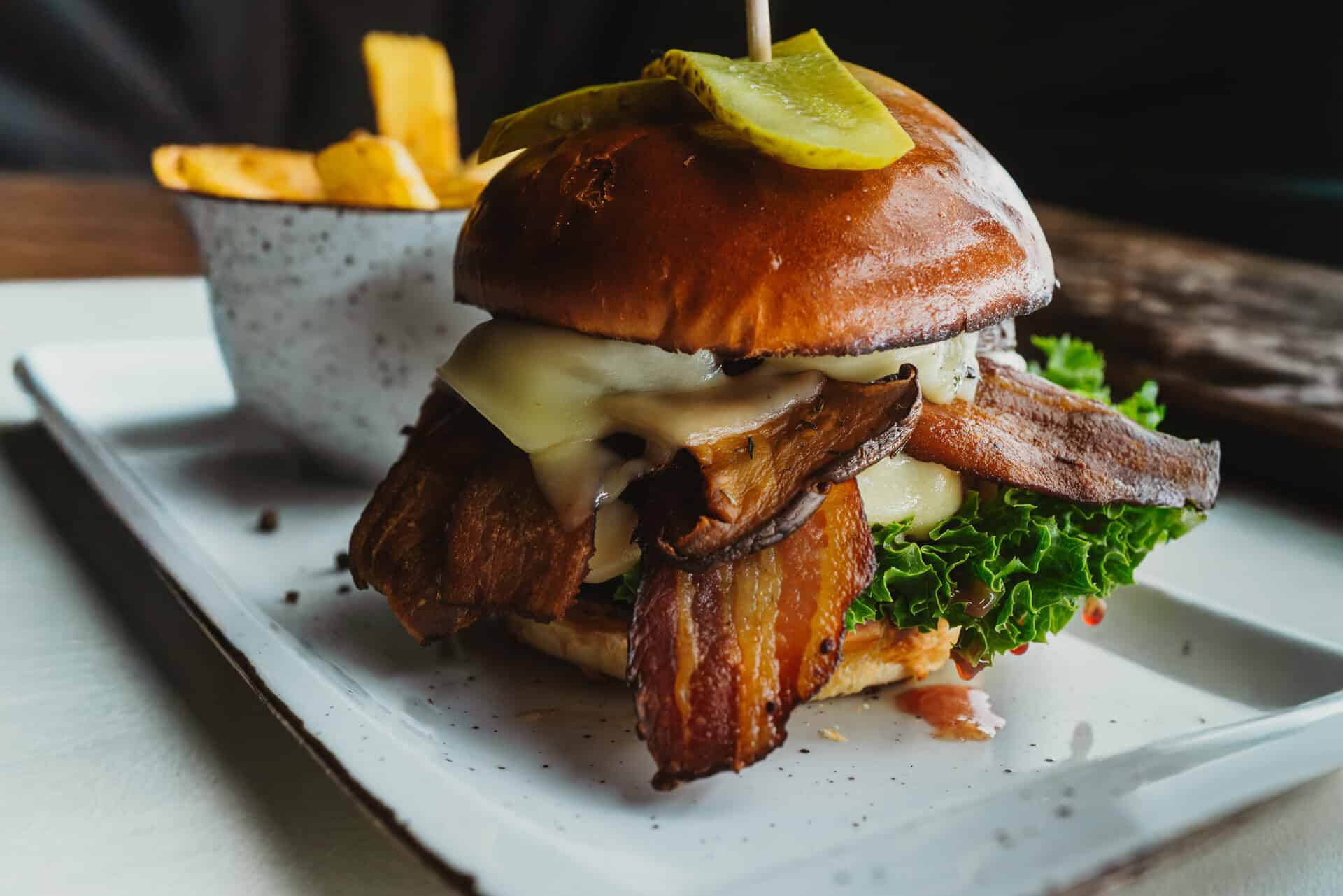 Burger with bacon, cheese, lettuce and pickles
