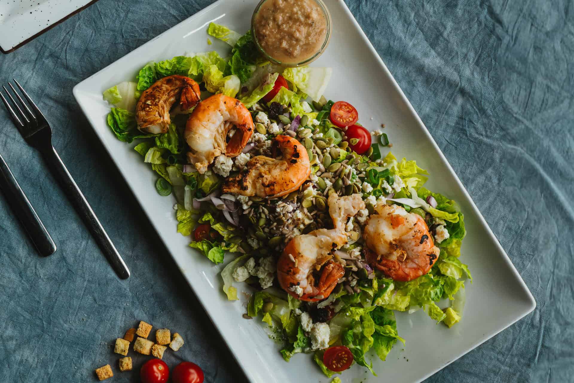 Fresh prawn salad with tomatoes and dressing